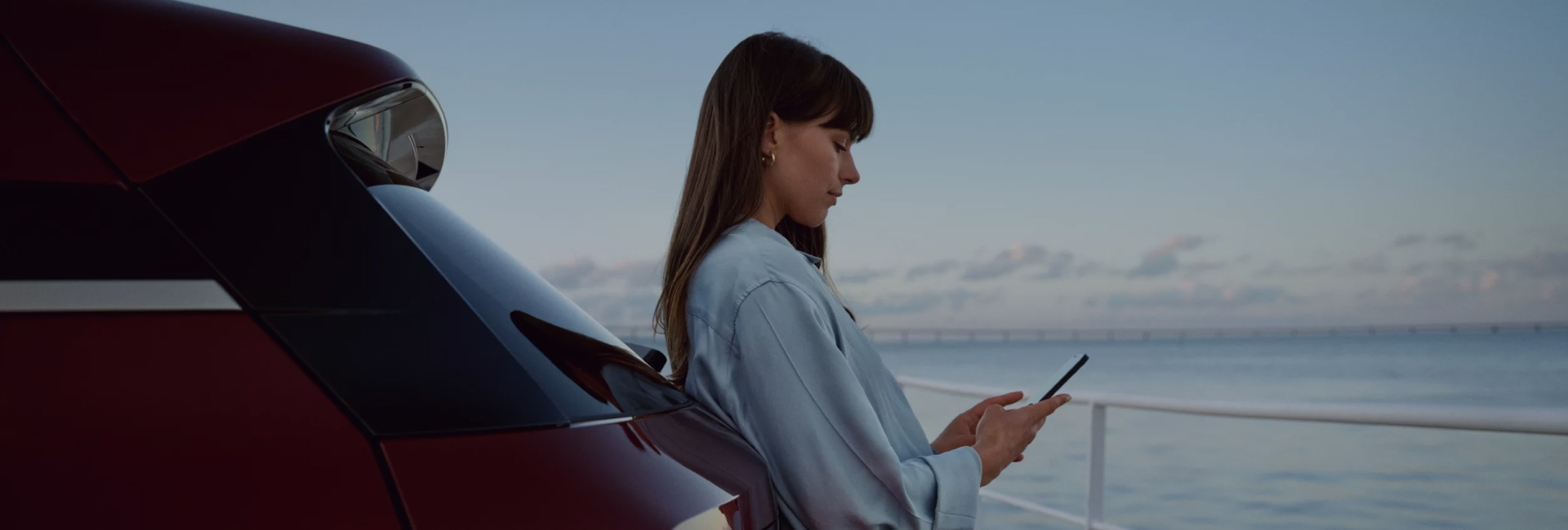 Woman with phone near car